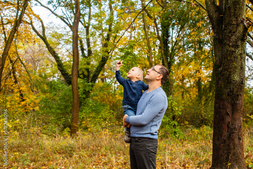 Dad and son in the autumn park