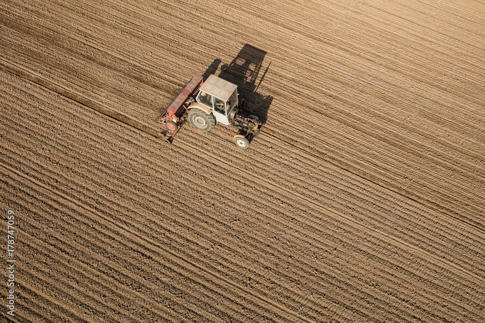 aerial view of the tractor on the harvest field aerial view of the tractor on the harvest field