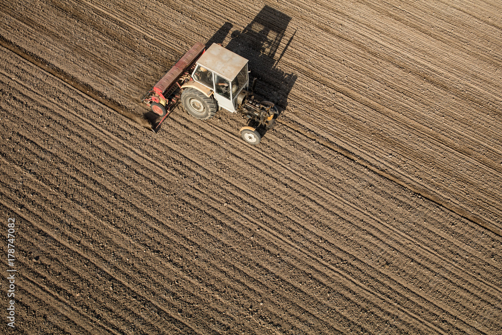 aerial view of the tractor on the harvest field aerial view of the tractor on the harvest field