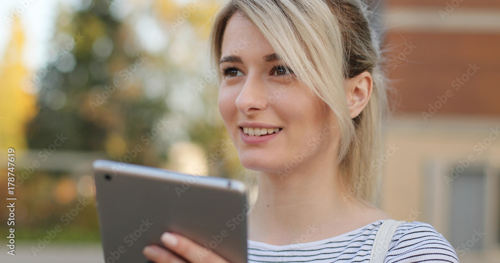 Woman using digital tablet PC in the park. Woman using digital tablet PC in the park.