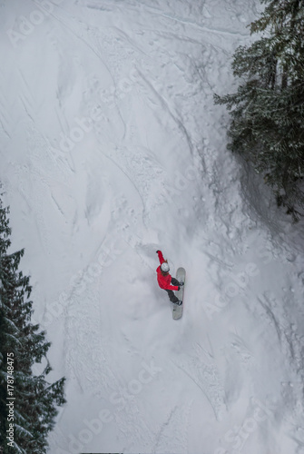 Lone snowboarder sliding down mountain