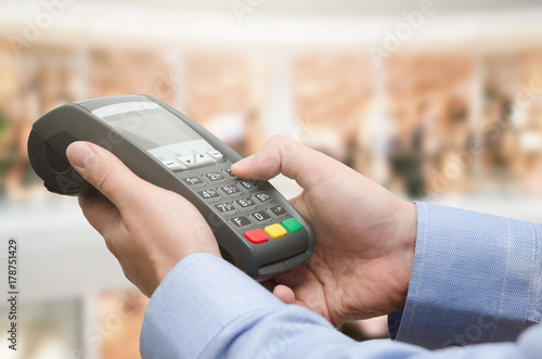 Hand using credit card payment machine