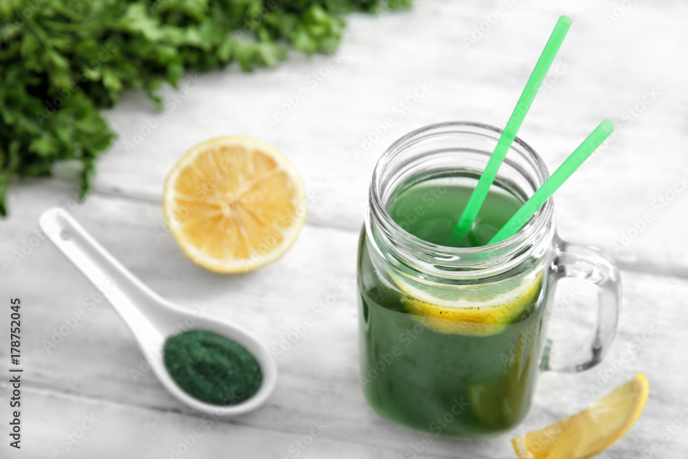 Mason jar with fresh spirulina drink on table Mason jar with fresh spirulina drink on table