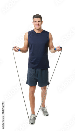 Young man with jumping rope...