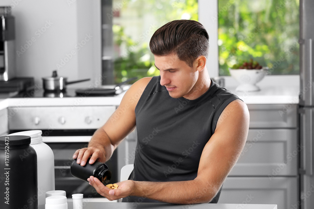Man holding jar with protein pills indoors Man holding jar with protein pills indoors