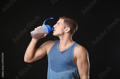 Young man drinking protein ...