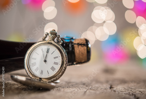 Champagne bottle and ancient clock as holiday background