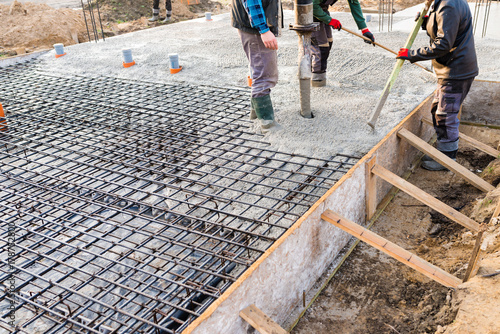 pouring concrete slab - foundation of new house photo