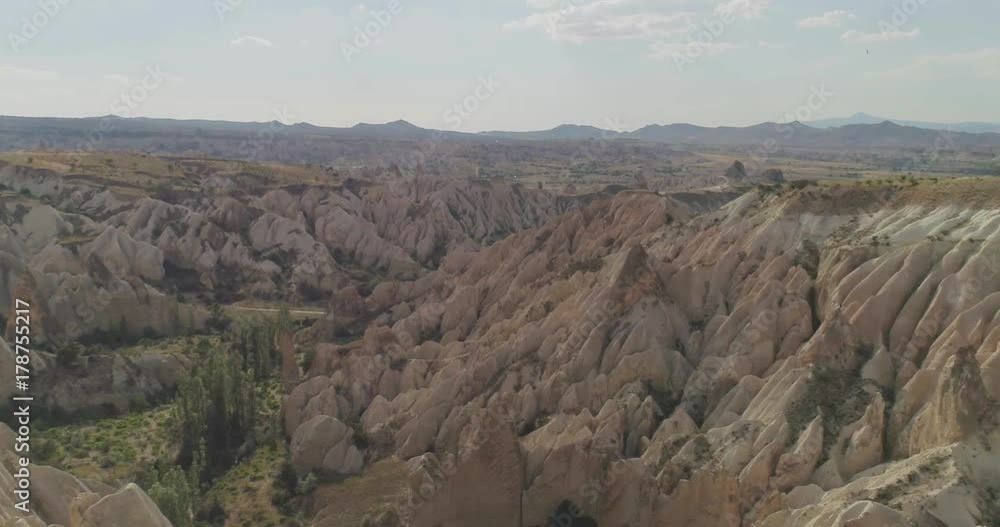 Aerial view of love valley in Goreme village, Turkey. countryside lifestyle. Top view of beautiful rural volcanic mountain landscape in Cappadocia. Travel,tourism and destination concept. Aerial view of love valley in Goreme village, Turkey. countryside lifestyle. Top view of beautiful rural volcanic mountain landscape in Cappadocia. Travel,tourism and destination concept.