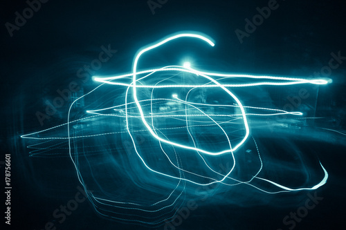 Blur colorful Abstract background of glowing stripes of streaks of light bands in a form of several lines on black background. Long Exposure.  