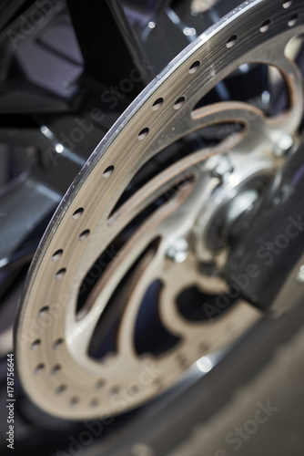 spokes and brake components on custom bike; macro closeup shot of rear motorcycle wheel