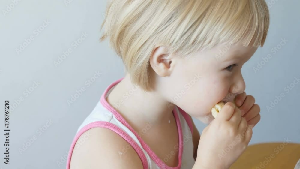 A little girl eating a pancake with her hands, close up, slow motion A little girl eating a pancake with her hands, close up, slow motion
