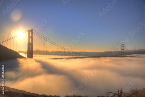 Fototapeta Naklejka Na Ścianę i Meble -  Spectacular Sunrise at Golden Gate Bridge with low fog. 
