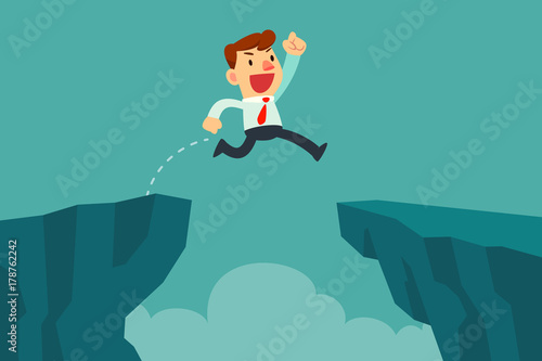 businessman jump over cliff gap