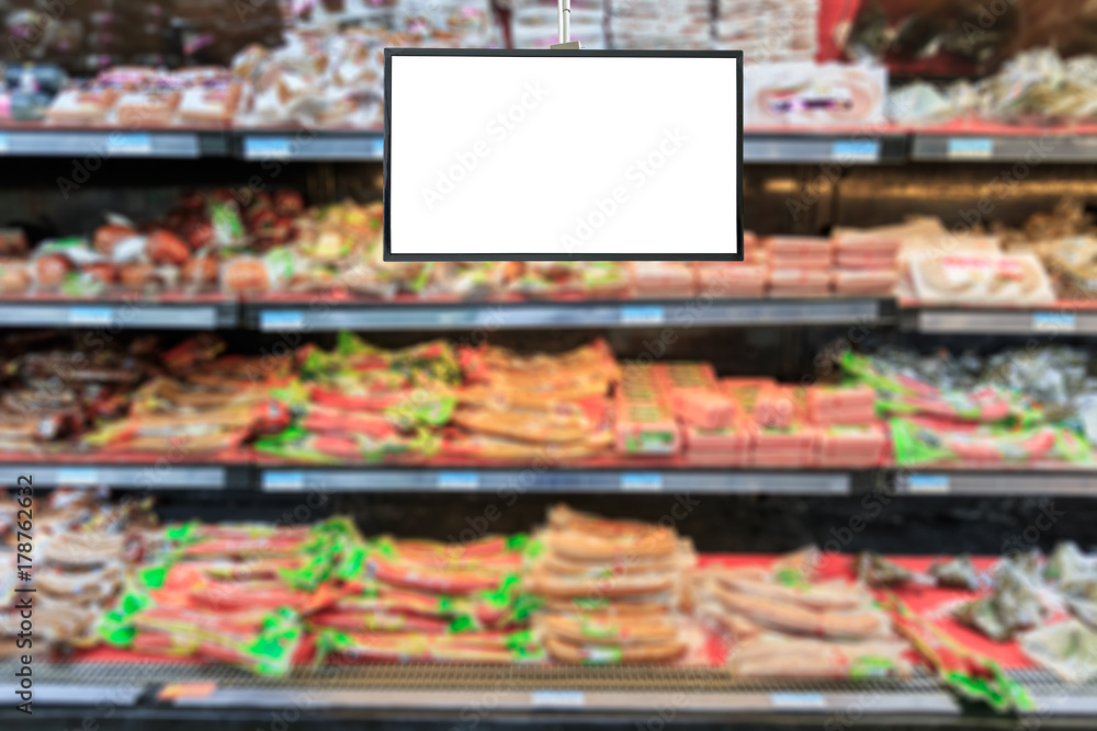 Blank supermarket TV screen and blurred supermarket ham sausage background