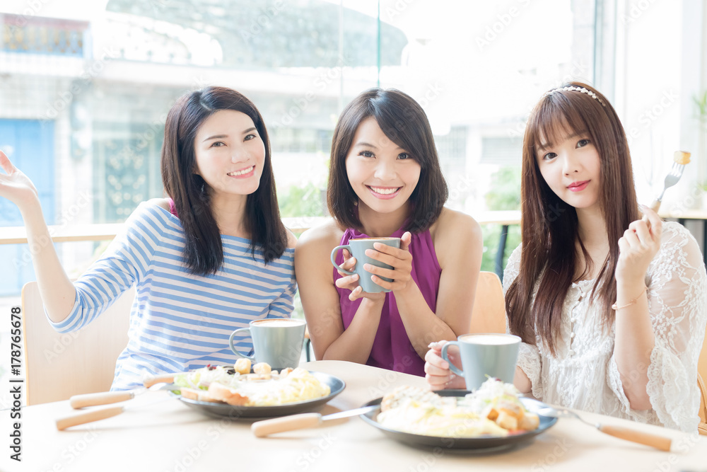 happy woman friends in restaurant