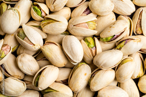Healthy and delicious roasted salted pistachio nuts background texture from top view photo