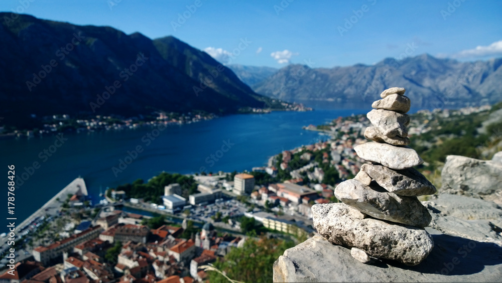 Pyramid made of stones by tourists climbing to the fortress in Kotor. Views of the Boka Bay from the height