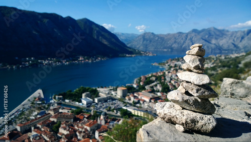 Obraz na płótnie Pyramid made of stones by tourists climbing to the fortress in Kotor. Views of the Boka Bay from the height w salonie