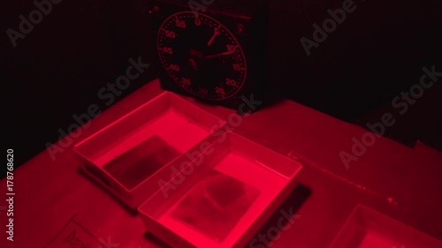 Photographer processes glass gelatin silver plates in a darkroom tent in the woods