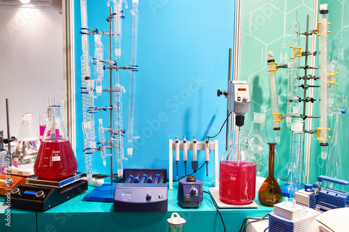 Flasks, burettes and shakers in chemical laboratory photo