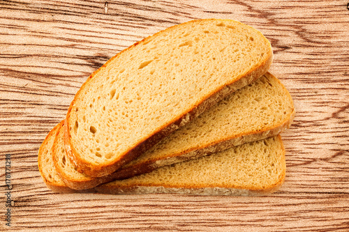 Slices of bread on wooden background