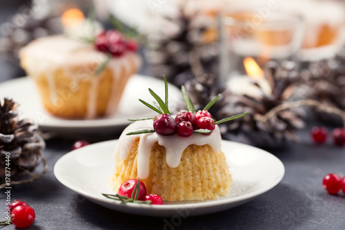 Christmas mini cake with sugar icing, cranberries and rosemary