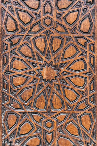 Relief ornament on a brown wooden surface