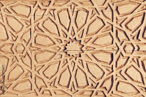 Relief ornament on the brown stone  background  texture