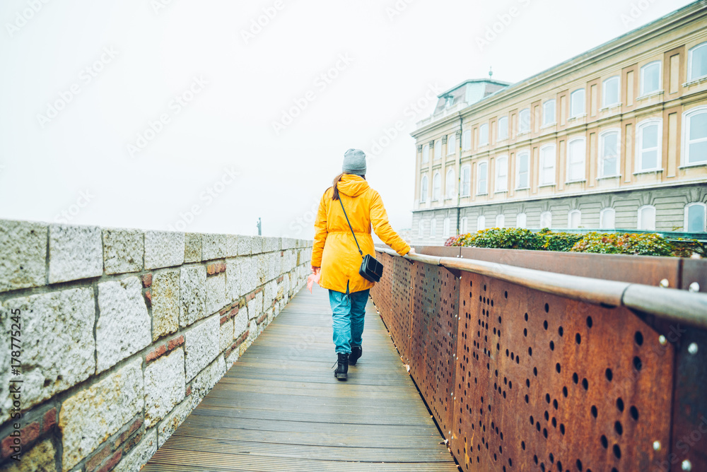 woman walking by tourist place in autumn day woman walking by tourist place in autumn day