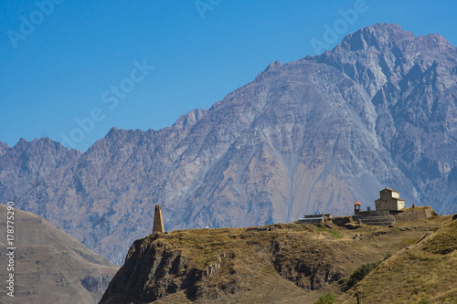 Ancient historical tower church on the mountain on the military Georgian road photo