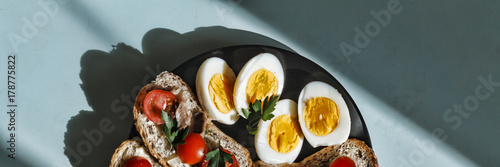 Healthy breakfast. Bruschettes with tomatoes and boiled eggs