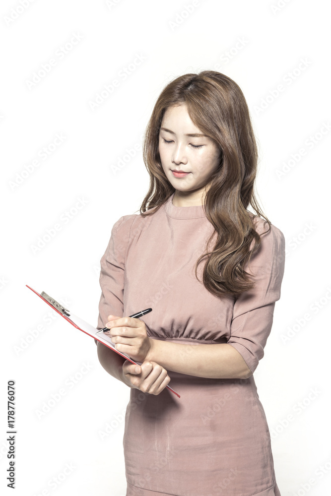 business woman standing up with clipboard and pencil at the studio business woman standing up with clipboard and pencil at the studio