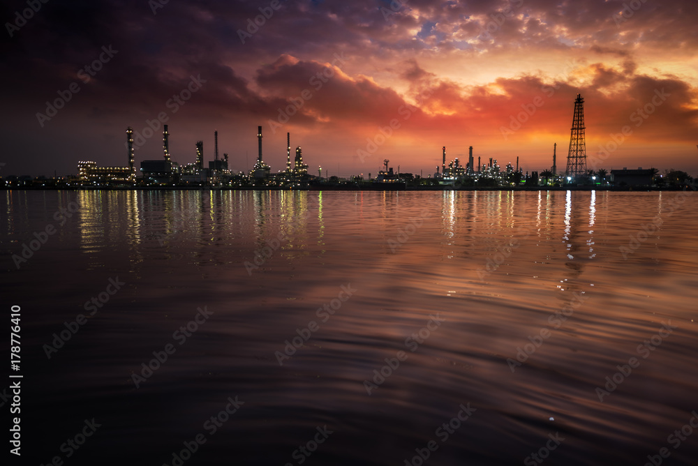 Fototapeta premium Oil and gas industry - refinery at Sunrise - factory - petrochemical plant with reflection over the river
