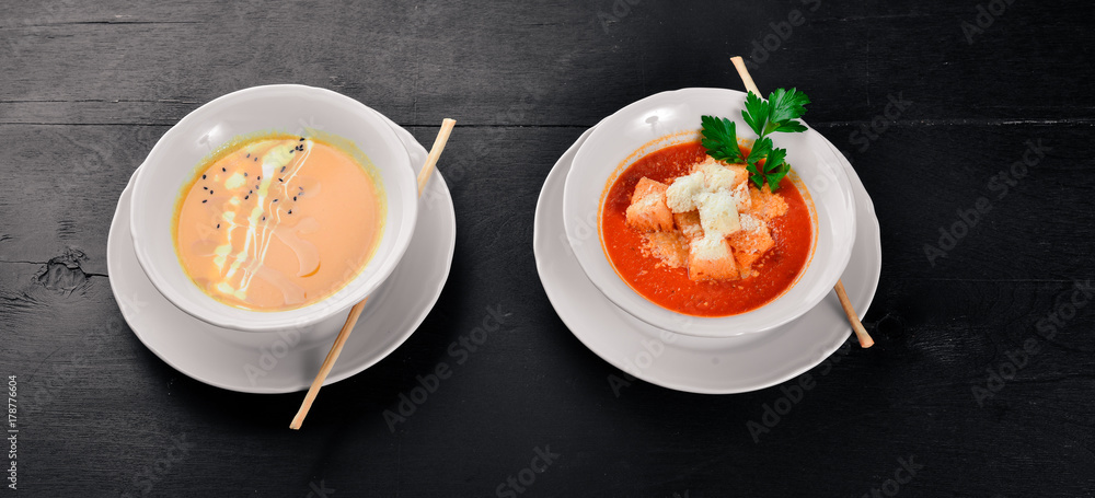 Tomato soup. On a wooden surface. Top view. Free space for your text. Tomato soup. On a wooden surface. Top view. Free space for your text.