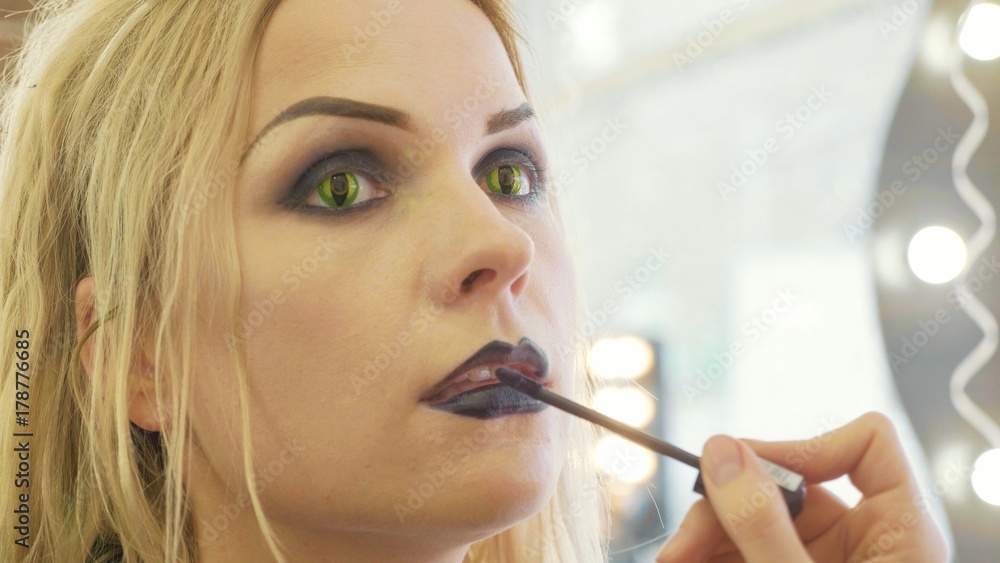 Process applying halloween makeup on face the young beautiful woman Process applying halloween makeup on face the young beautiful woman