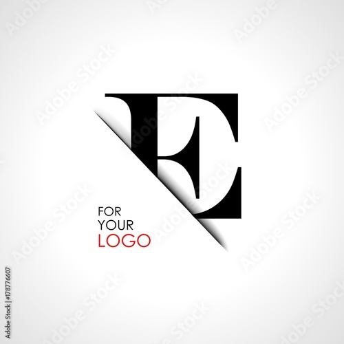 Capital e letter is inserted in the paper slot. To create logos, emblems, monograms.