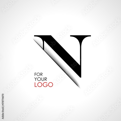 Capital n letter is inserted in the paper slot. To create logos, emblems, monograms. photo