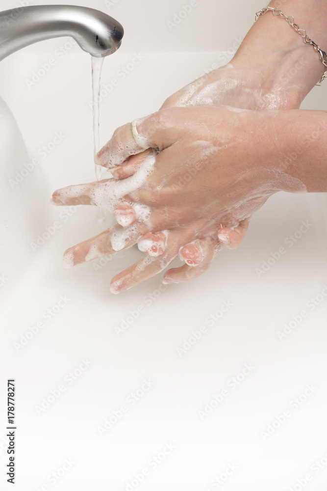 Soapy Hands Being Rinsed with Water Running From Tap Soapy Hands Being Rinsed with Water Running From Tap