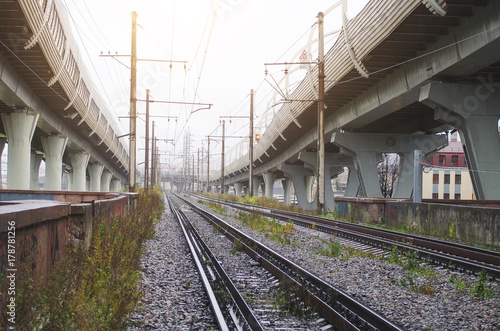 High-speed highway on high pillars at the bottom of the railway.