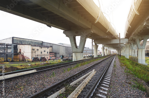 High-speed highway on high pillars at the bottom of the railway.