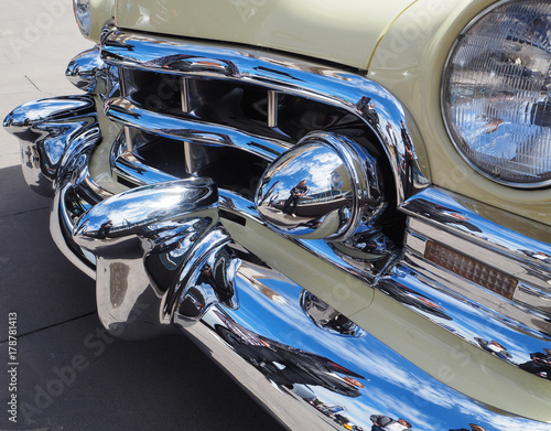 Front of a an American luxuary muscle car shoring large chrome fender photo