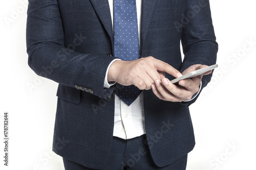 business man standing up with smart phone isolated white.