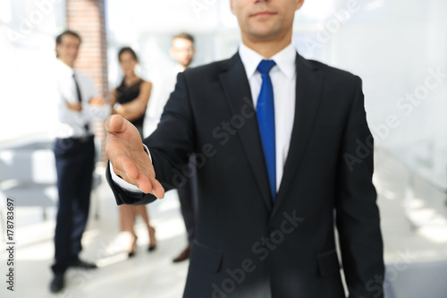 successful businessman giving a hand