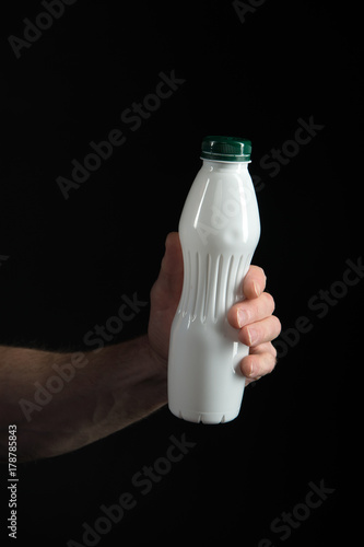 yoghurt bottle with healthy drink in hand of man