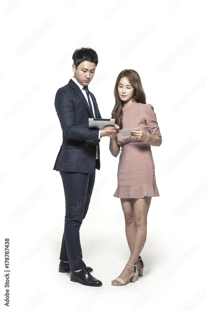 business man and woman standing up with smart device isolated white. business man and woman standing up with smart device isolated white.