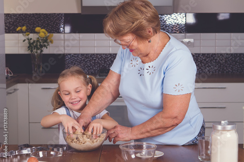 grandmother and granddaughter cook