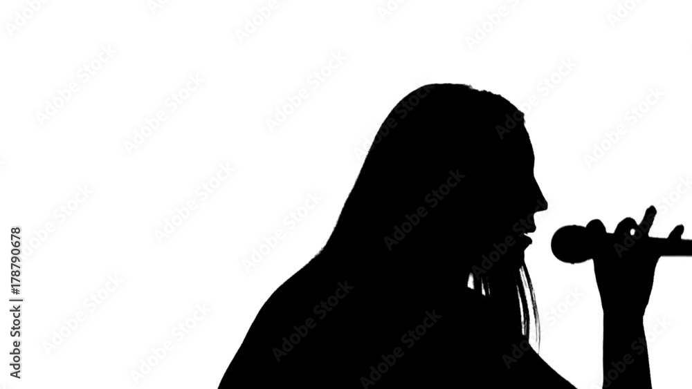 Girl and sings in a microphone silhouette Girl and sings in a microphone silhouette