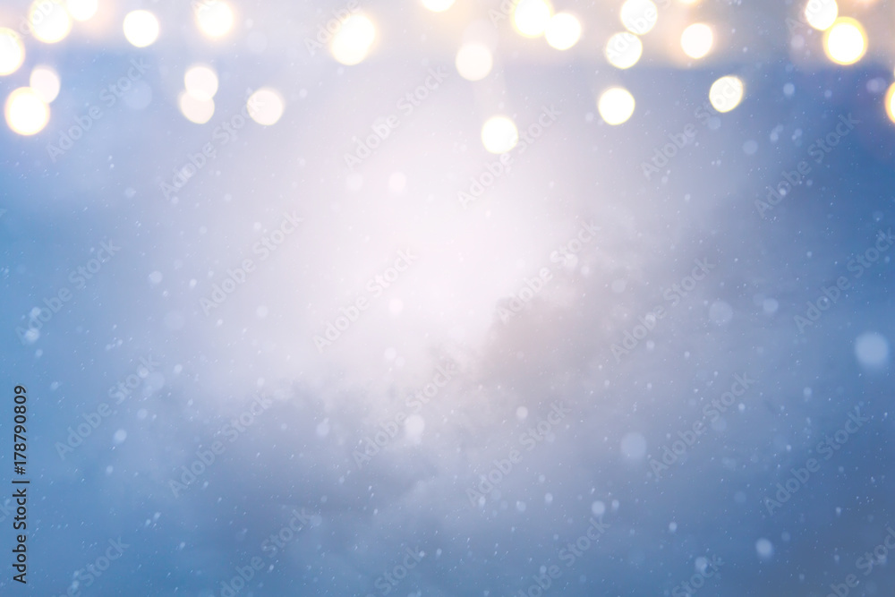 Obraz premium Christmas holidays lights on Winter snow sky background