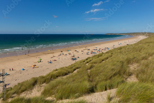 St Ives Bay beach Cornwall uk in summer with people blue sky and sea  view towards Godrevy lighthouse